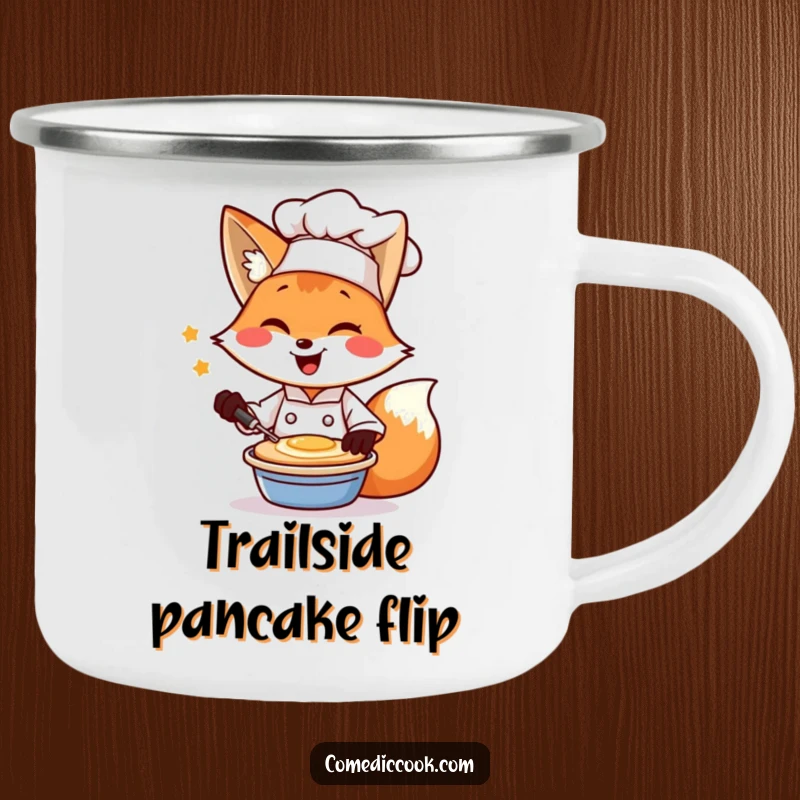 Funny enamel camping mug with a winking fox chef flipping a pancake, ideal for breakfast outdoors.