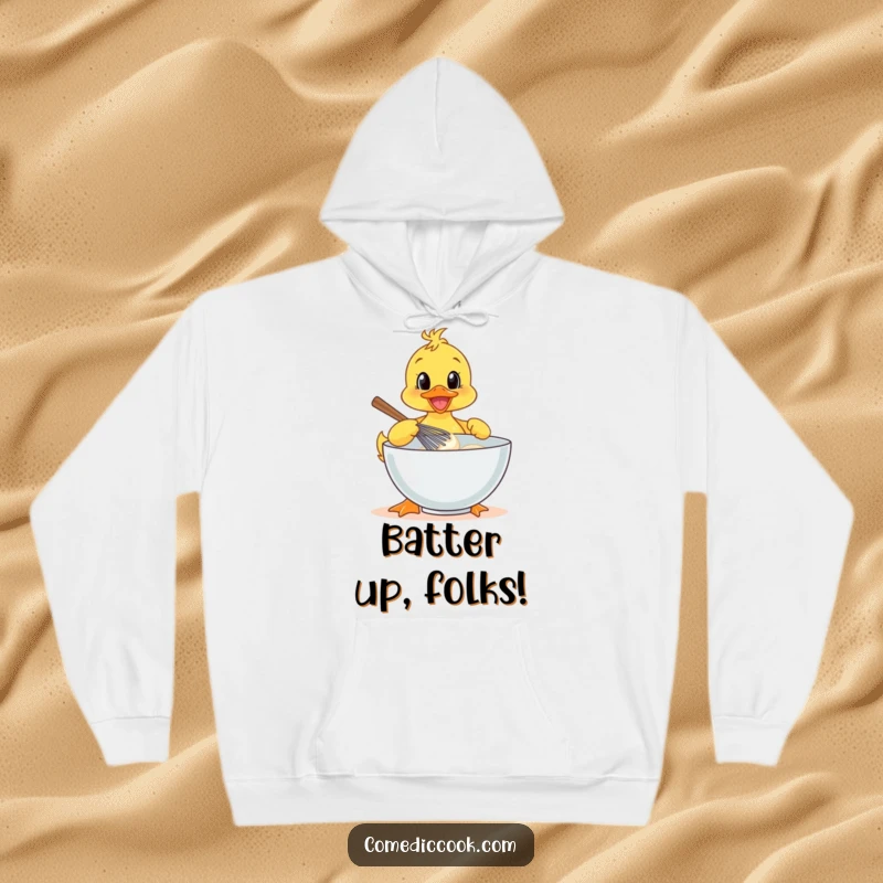 Funny duckling chef, wearing a hat, cheerfully whisking batter in a bowl, cozy hoodie design.