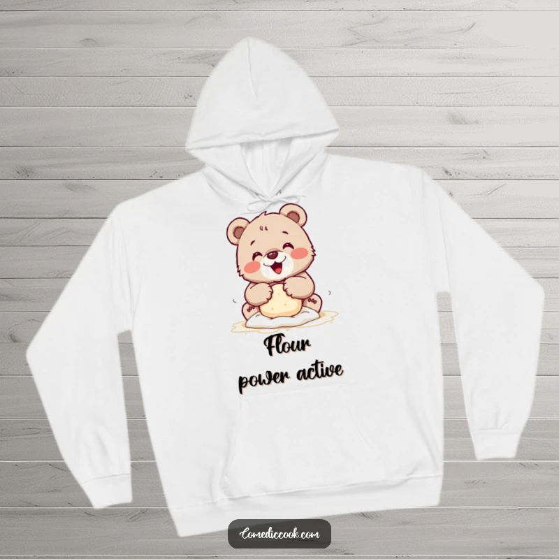 Funny hoodie featuring a tiny bear cub joyfully kneading dough with flour-dusted paws, providing warmth and baking cheer.