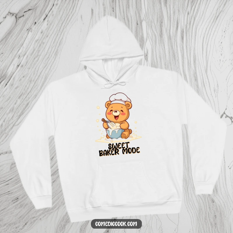 Funny hoodie with a kawaii chef bear whisking batter in a flour cloud, offering warmth and humorous baking vibes.