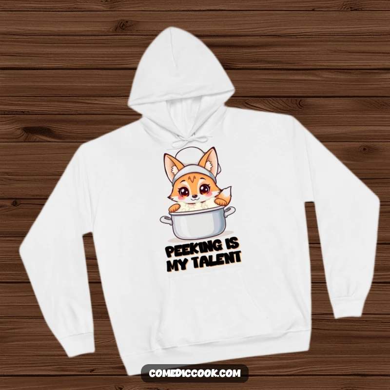 Funny fox chef hoodie featuring a curious fox peeking into a bubbling pot, perfect for staying warm and sharing a laugh, a great gift.