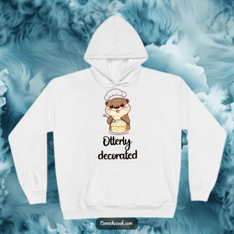 Funny otter chef hoodie with a happy otter decorating a tiny cake with sprinkles, perfect for staying warm and spreading smiles, a great gift.