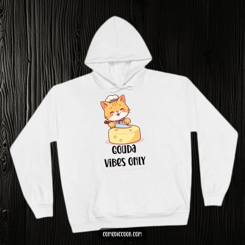 Funny Cat Chef Hoodie depicting a happy cat focused on slicing a very large cheese wheel, ideal for cozy, humorous, and warm gifting.