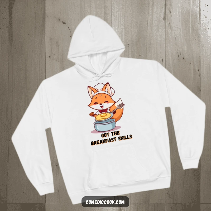 Funny Fox Chef Hoodie: Cheerful fox expert at flipping pancakes, offering warmth and humor for chefs.